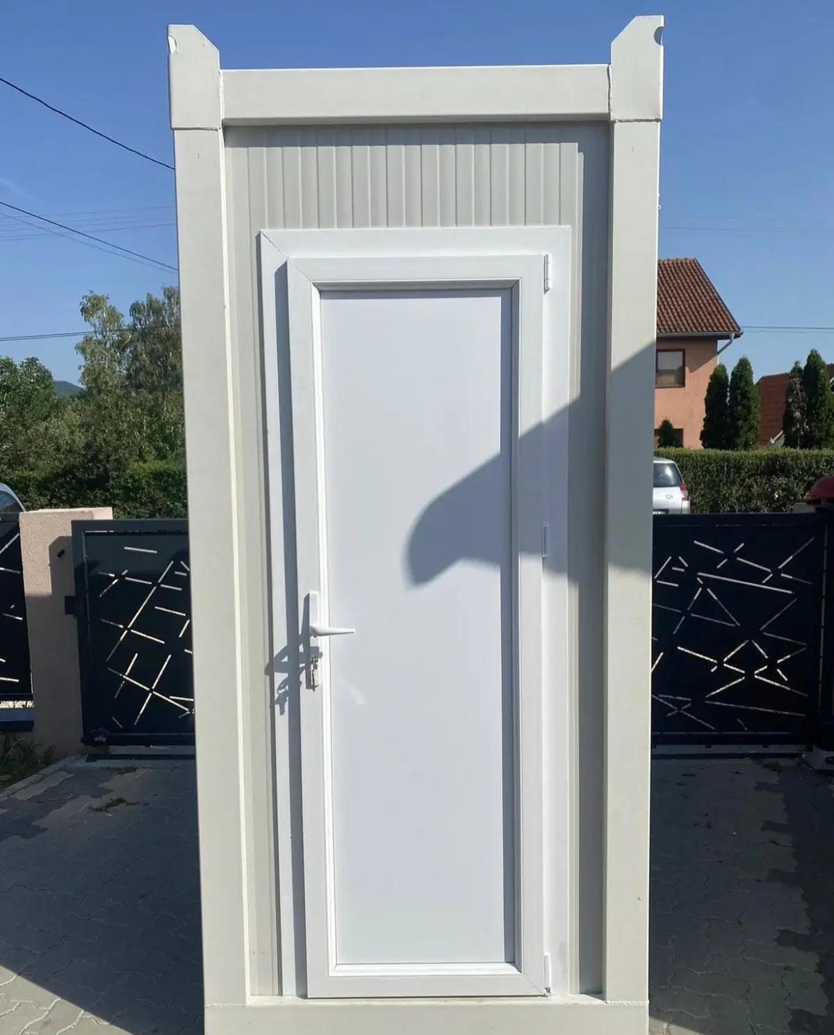 Outside of a flushing portable restroom cabin
