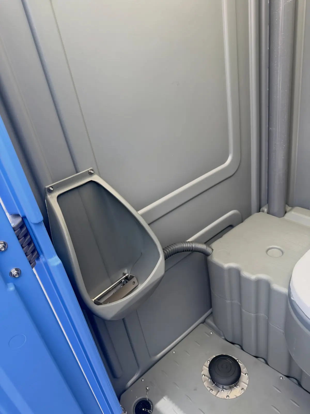 Close view of the urinal inside a standard portable toilet