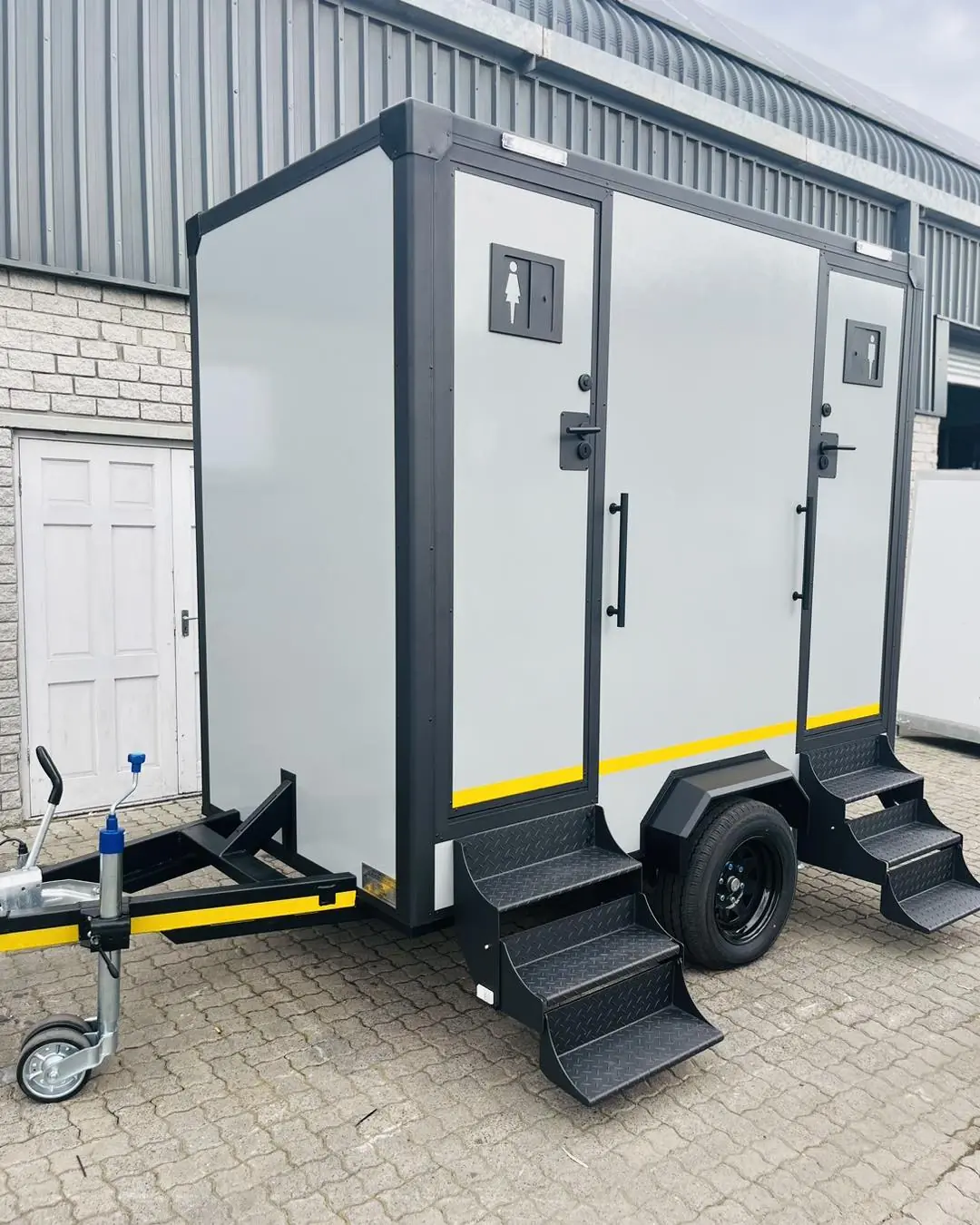 Two-stall restroom trailer parked on level ground